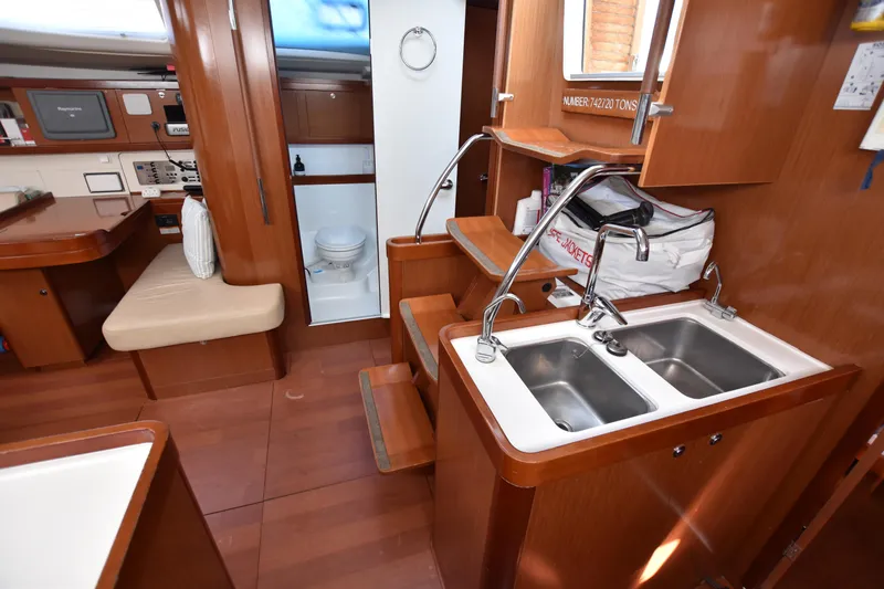 Panope Yacht Photos Pics Interior of 2009 Beneteau Oceanis 54 yacht with kitchen and seating area.