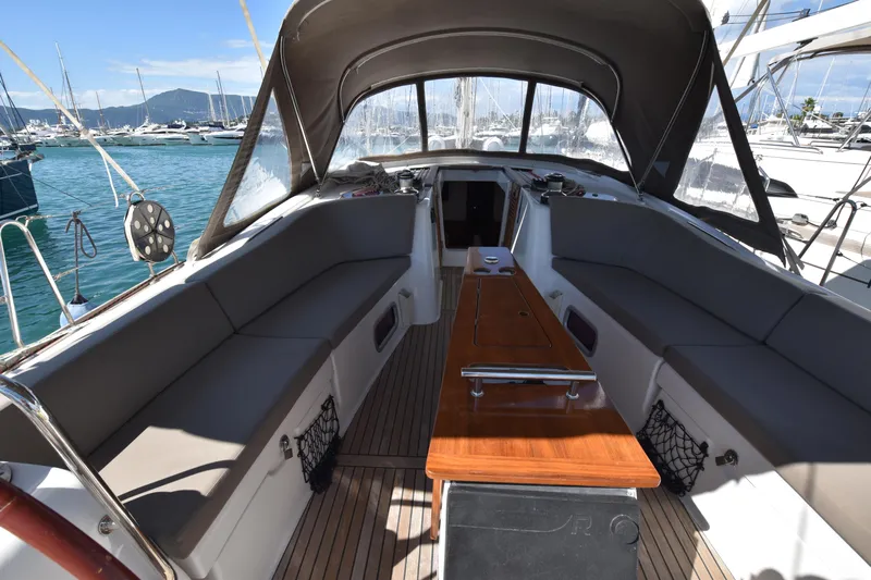 Panope Yacht Photos Pics Spacious cockpit of 2009 Beneteau Oceanis 54 yacht with comfortable seating and wooden table.