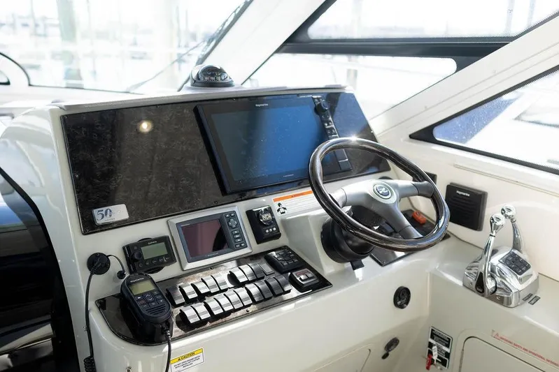 Kylie Marie Yacht Photos Pics 2009 Searay 43 Sundancer helm with navigation controls and steering wheel.