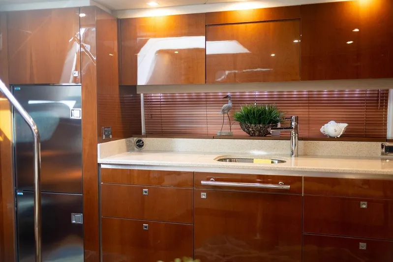 Kylie Marie Yacht Photos Pics Luxurious kitchen interior of 2009 Searay 43 Sundancer yacht with wood cabinetry.