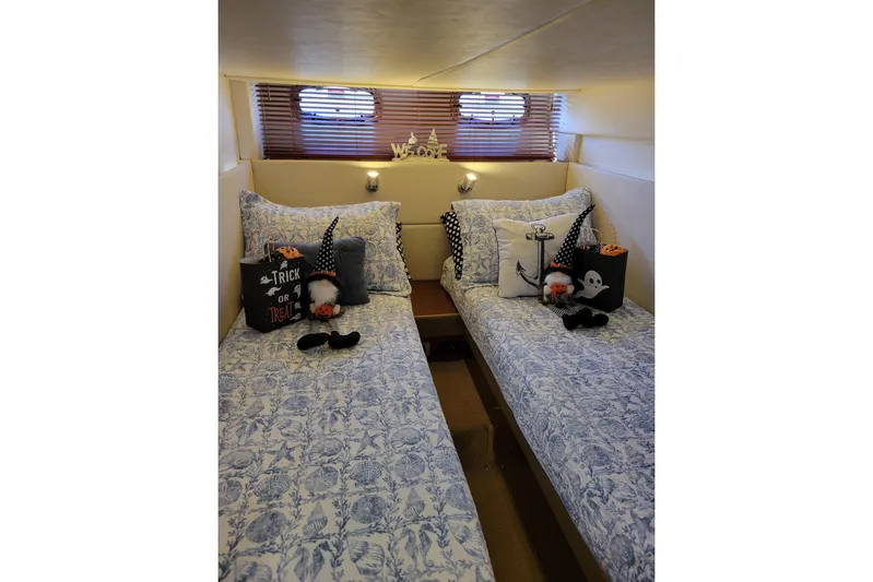 Kylie Marie Yacht Photos Pics Cozy cabin with twin beds, nautical decor, and Halloween accents on 2009 Searay 43 Sundancer.