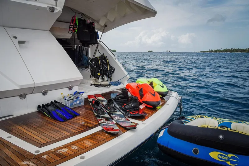 Escape Yacht Photos Pics Sunseeker 68 Sport Yacht 2014 with water sports gear on deck, ocean backdrop.