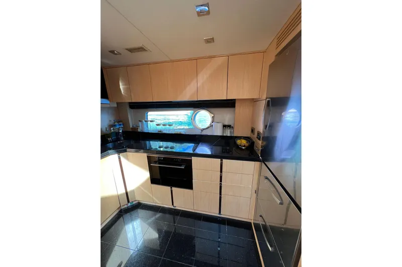 Escape Yacht Photos Pics Luxurious kitchen interior of 2014 Sunseeker 68 Sport Yacht with modern appliances.