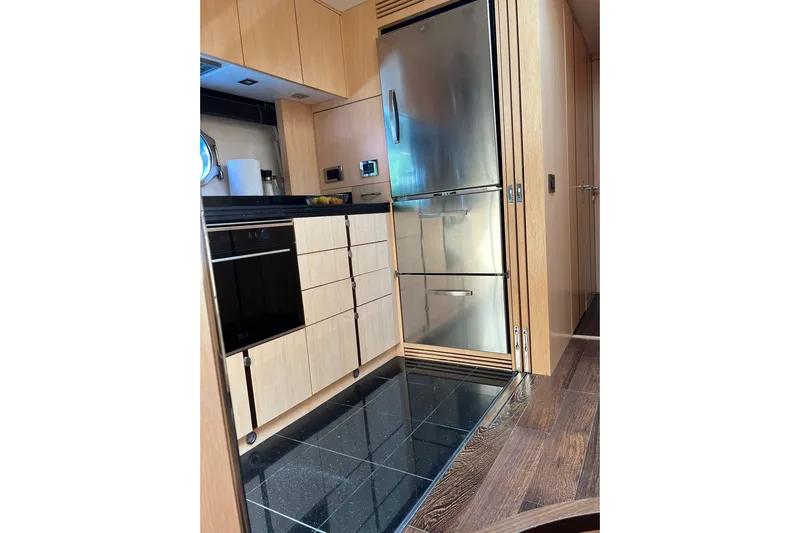 Escape Yacht Photos Pics Modern kitchen interior of 2014 Sunseeker 68 Sport Yacht with stainless steel appliances.