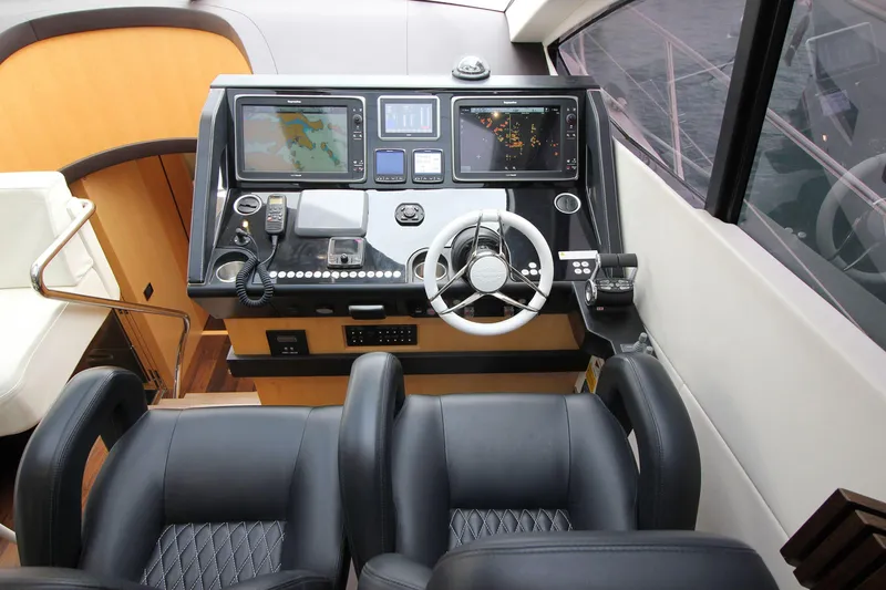 Escape Yacht Photos Pics Helm of 2014 Sunseeker 68 Sport Yacht with navigation screens and controls.
