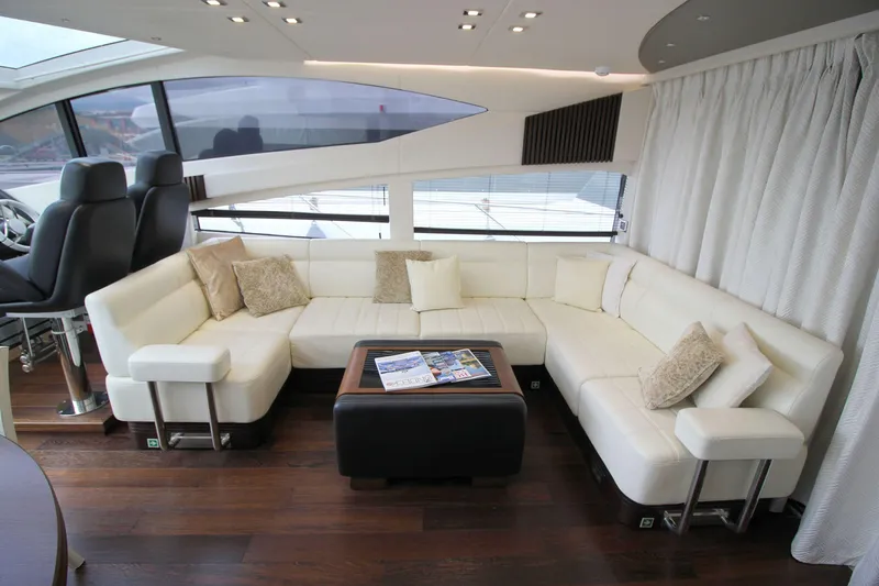 Escape Yacht Photos Pics Luxurious interior of 2014 Sunseeker 68 Sport Yacht with white leather seating and modern decor.