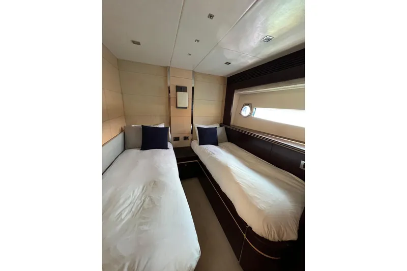 Escape Yacht Photos Pics Twin bedroom in 2014 Sunseeker 68 Sport Yacht, featuring modern design and porthole window.