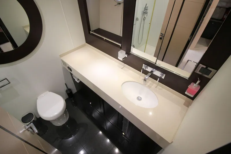 Escape Yacht Photos Pics Luxurious bathroom in 2014 Sunseeker 68 Sport Yacht, featuring modern fixtures and sleek design.