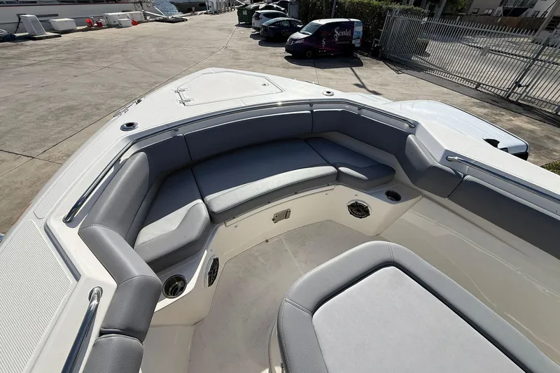  Yacht Photos Pics 2023 Boston Whaler 280 Outrage boat interior with cushioned seating area.