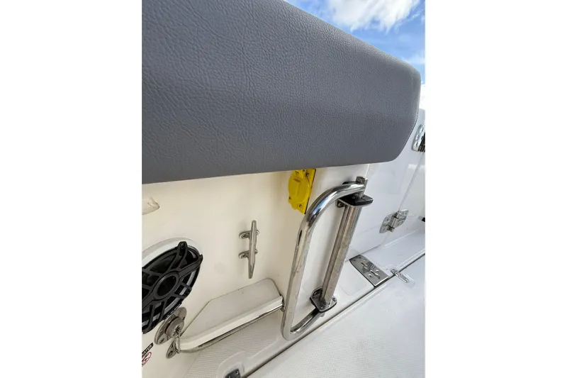  Yacht Photos Pics 2023 Boston Whaler 280 Outrage boat interior with speaker and stainless steel railing.