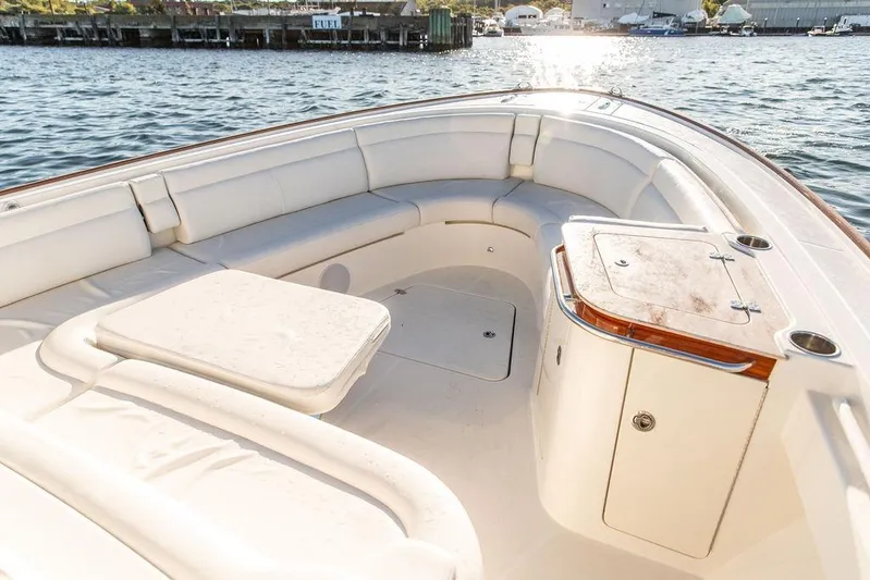 Stargazer Yacht Photos Pics 2024 Hinckley Sport Boat 40c interior with white seating and wooden accents on water.