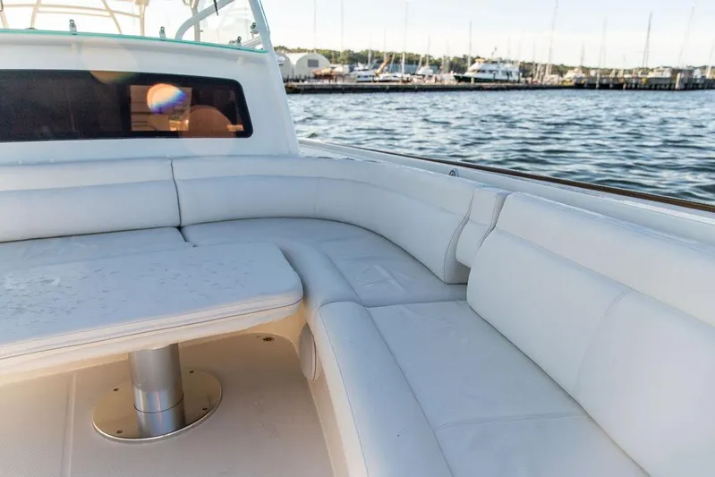 Stargazer Yacht Photos Pics 2024 Hinckley Sport Boat 40c with white seating, docked by the marina.