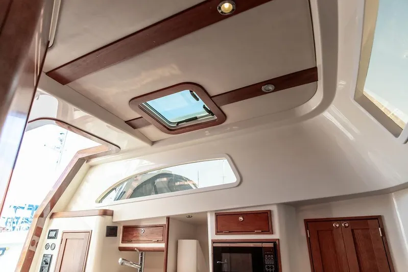 Stargazer Yacht Photos Pics 2024 Hinckley Sport Boat 40c interior with skylight and wooden cabinetry.