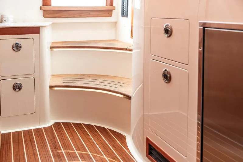 Stargazer Yacht Photos Pics Interior of 2024 Hinckley Sport Boat 40c with wooden steps and cabinetry.