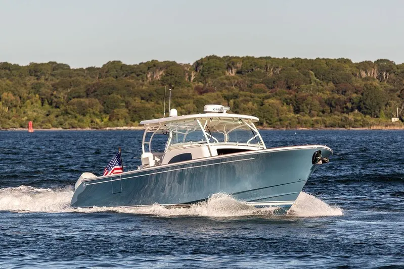 Stargazer Yacht Photos Pics 2024 Hinckley Sport Boat 40c cruising on a scenic lake with forested background.