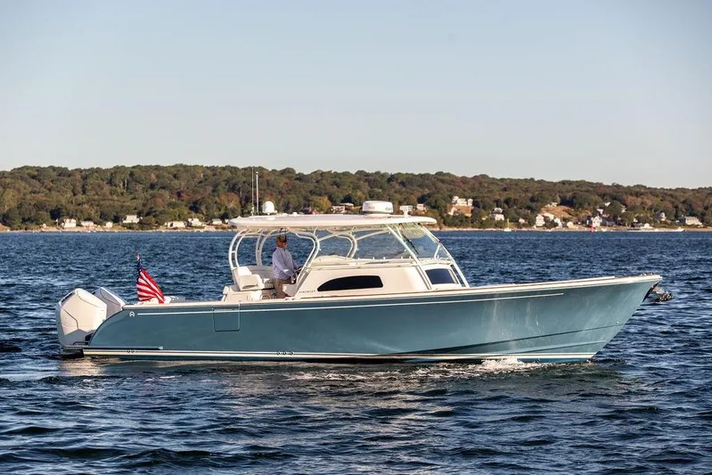 Stargazer Yacht Photos Pics 2024 Hinckley Sport Boat 40c cruising on a scenic lake with shoreline view.