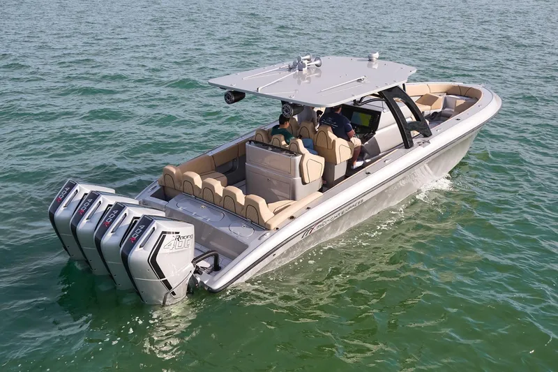  Yacht Photos Pics 2024 Midnight Express 37' Open boat cruising on water with triple outboard engines.