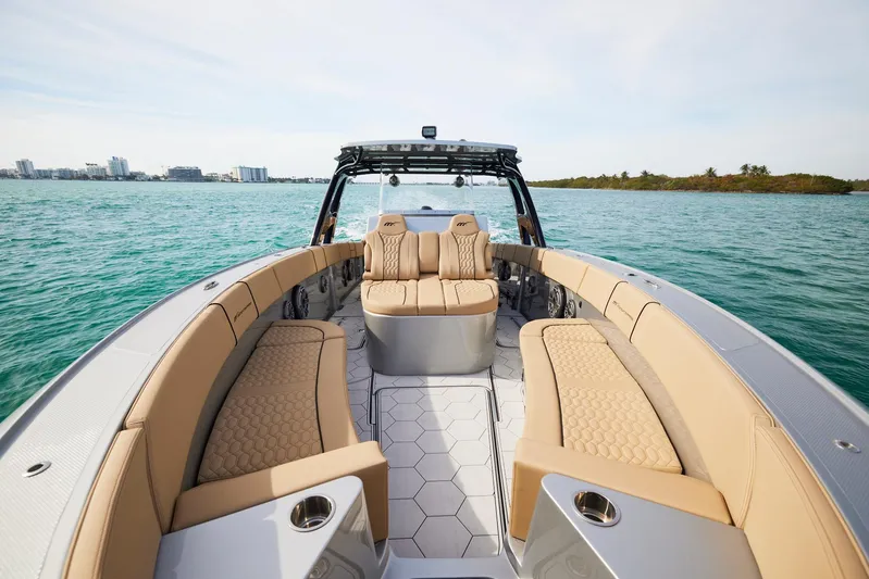  Yacht Photos Pics 2024 Midnight Express 37' Open boat with luxurious seating on calm waters.