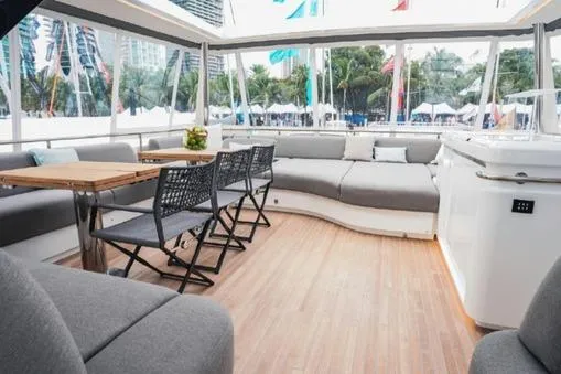 4ever VI Yacht Photos Pics Spacious interior of 2022 Lagoon 67 yacht with modern seating and dining area.