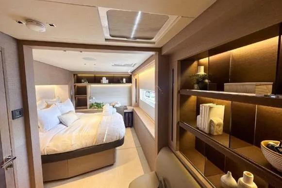 4ever VI Yacht Photos Pics Luxurious interior of a 2022 Lagoon 67 yacht with elegant bedroom and shelving.