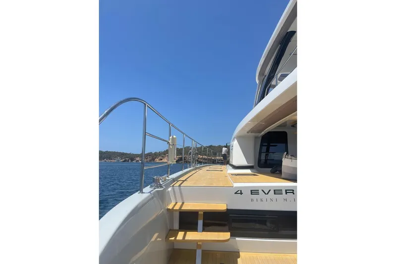 4ever VI Yacht Photos Pics Luxurious 2022 Lagoon 67 yacht deck with ocean view and clear blue sky.
