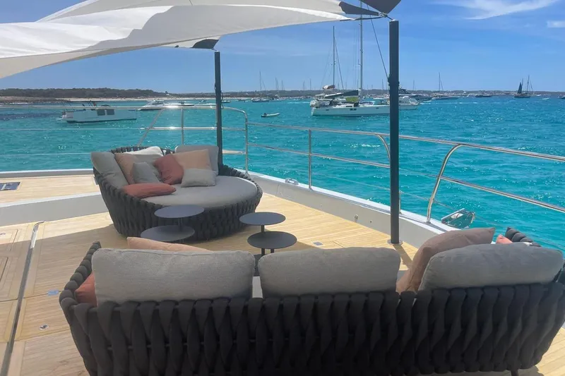 4ever VI Yacht Photos Pics Luxurious Lagoon 67 yacht deck with cozy seating, overlooking turquoise waters, 2022 model.