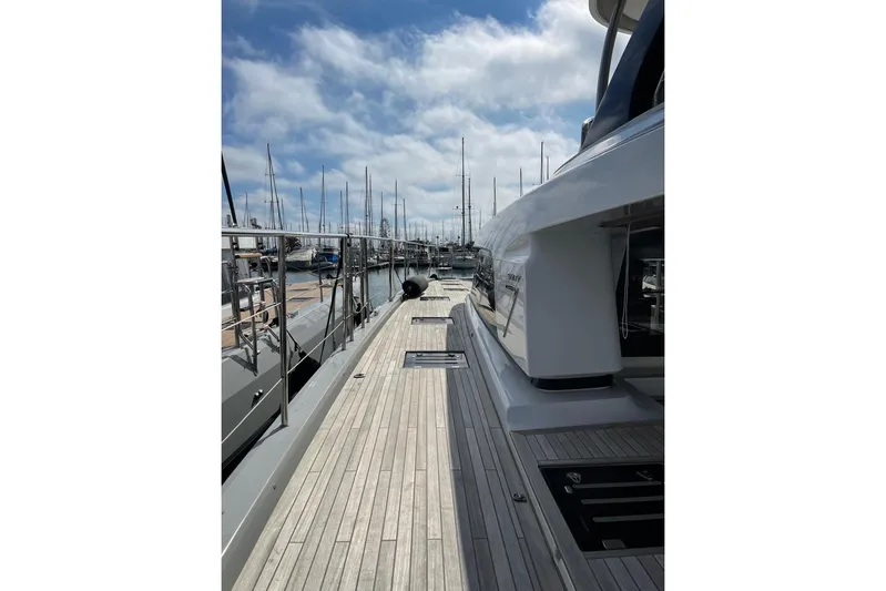 4ever VI Yacht Photos Pics Side view of 2022 Lagoon 67 yacht docked at marina under blue sky.
