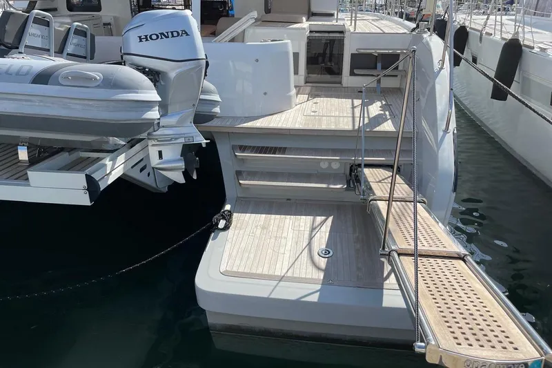 4ever VI Yacht Photos Pics Luxury Lagoon 67 yacht stern with Honda outboard motor and wooden deck, 2022 model.