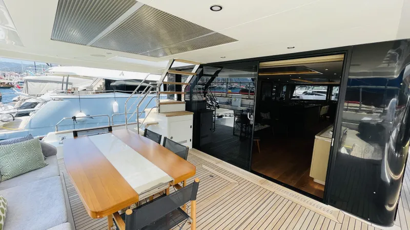  Yacht Photos Pics Luxurious 2024 Sirena 78 yacht deck with dining area and modern interior view.
