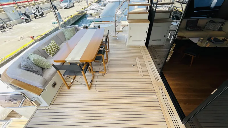  Yacht Photos Pics Luxurious 2024 Sirena 78 yacht deck with elegant seating and dining area.