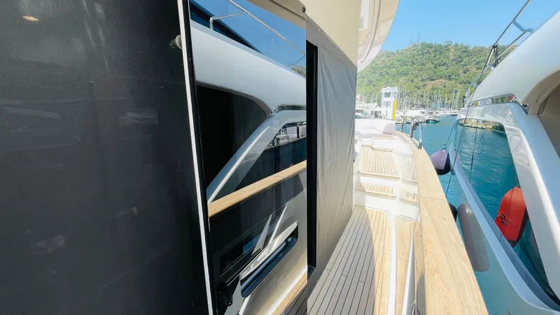  Yacht Photos Pics 2024 Sirena 78 yacht deck with sleek design and scenic marina view.