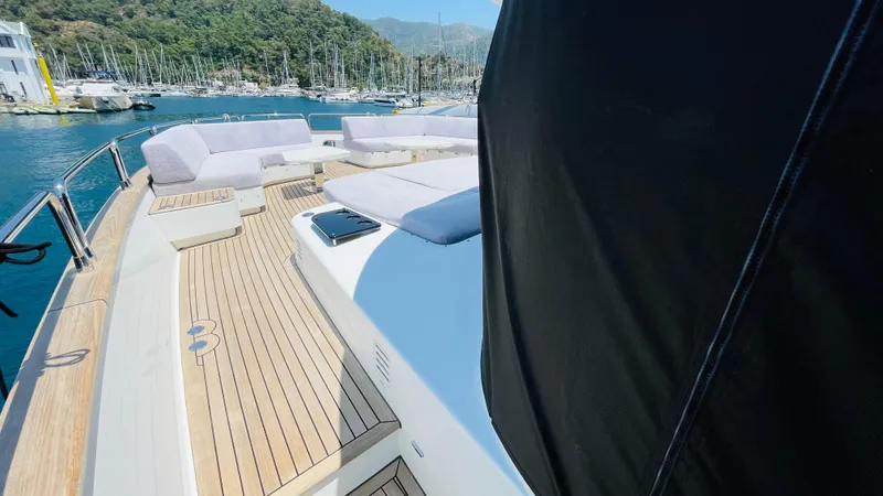  Yacht Photos Pics Luxurious 2024 Sirena 78 yacht deck with seating, docked in a scenic marina.