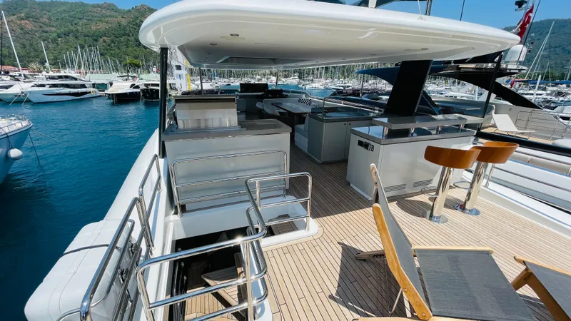  Yacht Photos Pics Luxurious 2024 Sirena 78 yacht deck with seating and marina view.