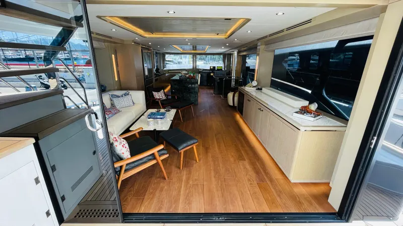  Yacht Photos Pics Luxurious interior of 2024 Sirena 78 yacht with modern furnishings and wooden flooring.