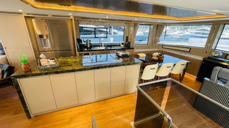  Yacht Photos Pics Luxurious interior of 2024 Sirena 78 yacht with modern kitchen and dining area.