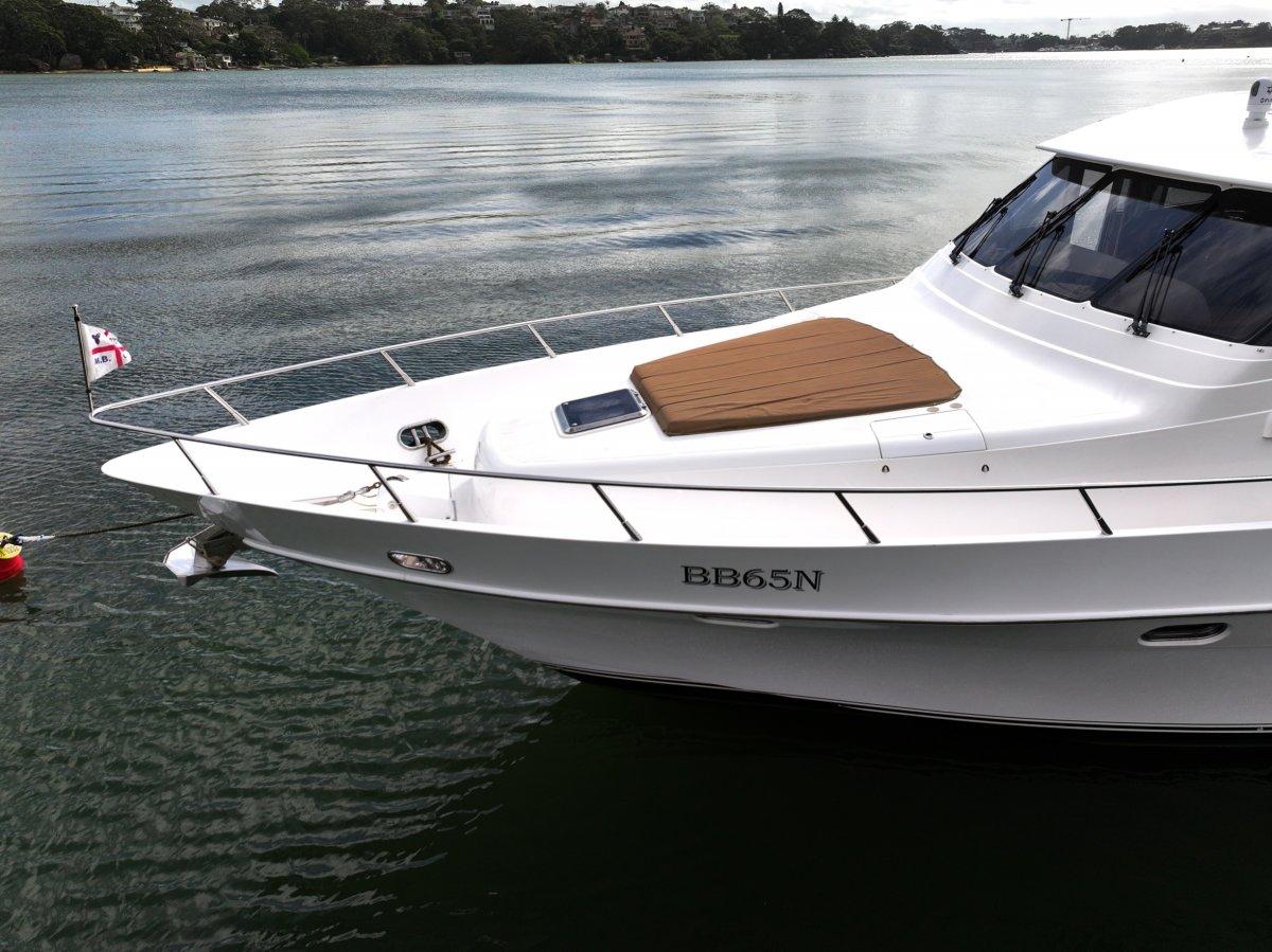 2011 Pama 65 Pilot House yacht on calm water, featuring sleek design and spacious deck.