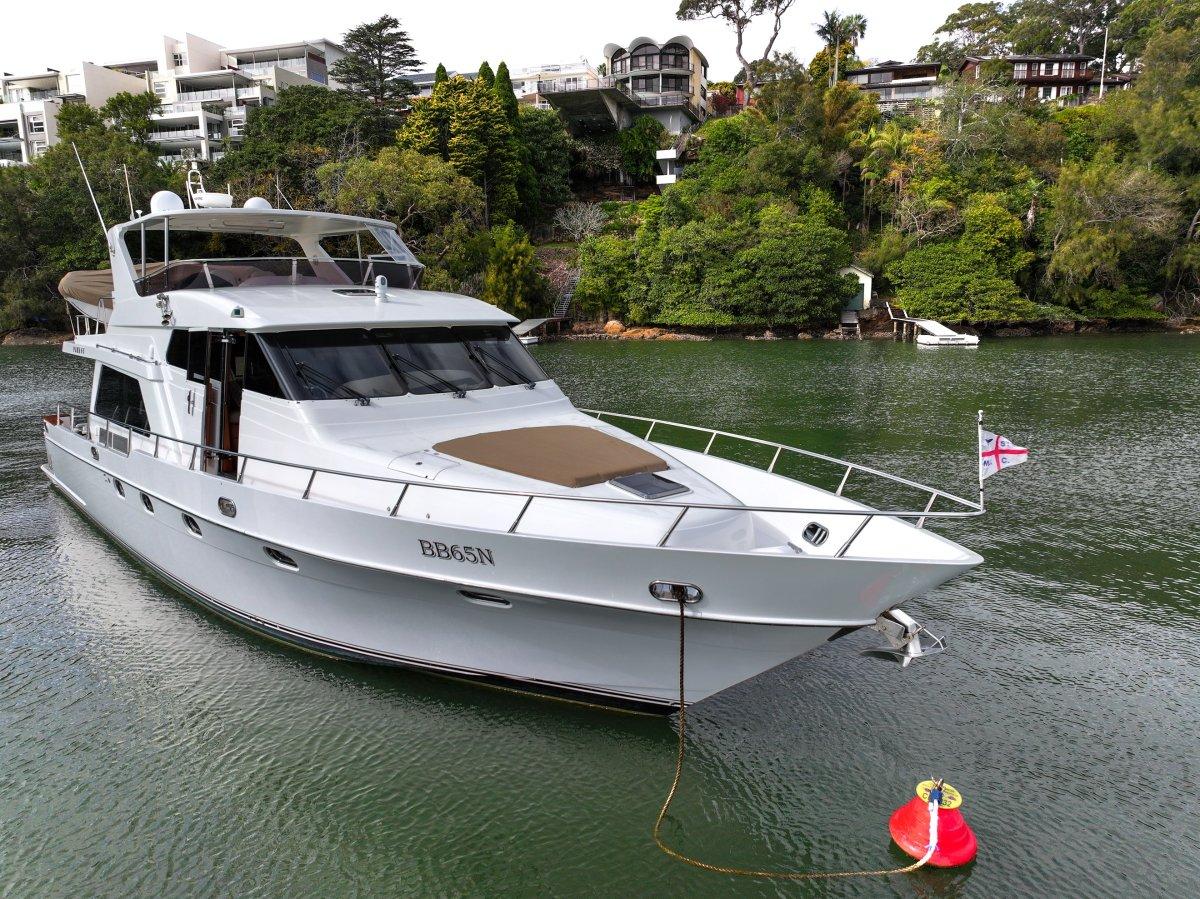 Luxury 2011 Pama 65 Pilot House yacht anchored in scenic waters.