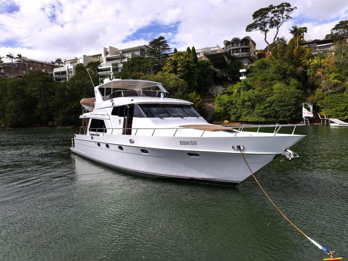 Pama 65 Pilot House Yacht Photos Pics 2011 Pama 65 Pilot House yacht anchored in a scenic waterfront setting.