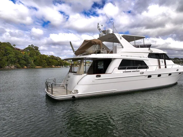 Pama 65 Pilot House Yacht Photos Pics Luxury 2011 Pama 65 Pilot House yacht on serene water with cloudy sky.