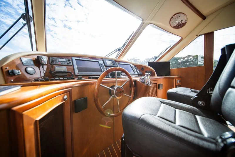 Pama 65 Pilot House Yacht Photos Pics Interior of 2011 Pama 65 Pilot House yacht with steering wheel and navigation equipment.