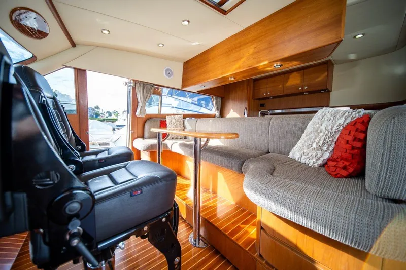 Pama 65 Pilot House Yacht Photos Pics Luxurious interior of 2011 Pama 65 Pilot House yacht with plush seating and elegant wood finishes.