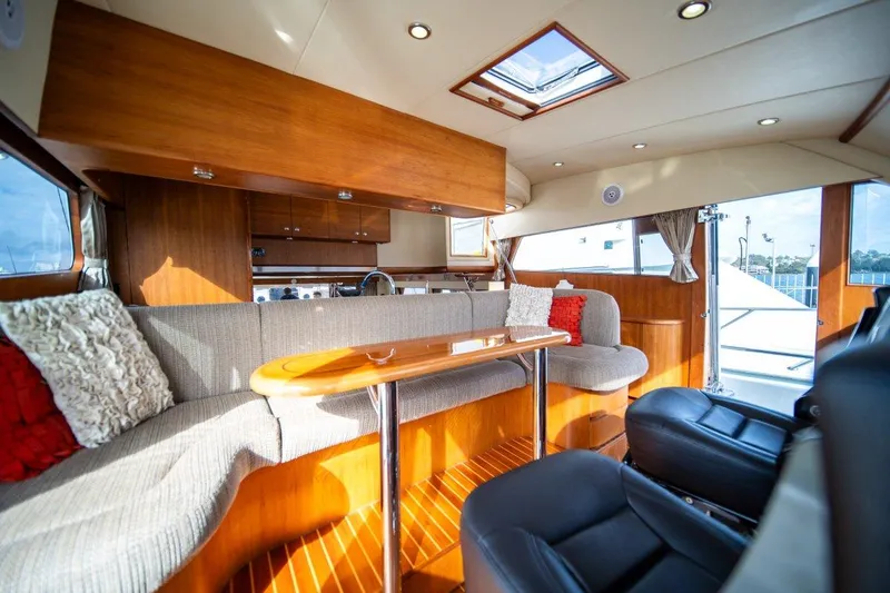 Pama 65 Pilot House Yacht Photos Pics Luxurious interior of 2011 Pama 65 Pilot House yacht with elegant seating and wooden finishes.
