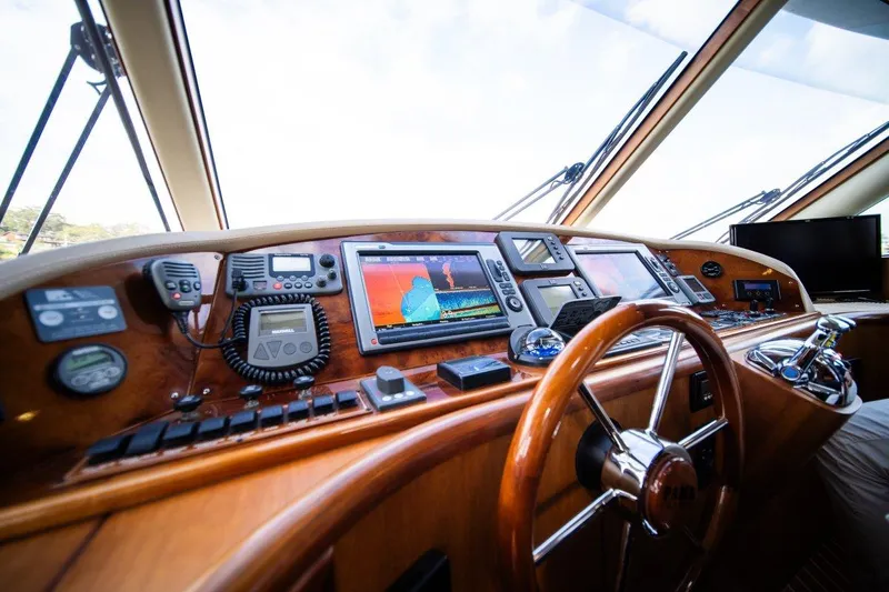 Pama 65 Pilot House Yacht Photos Pics Control panel of 2011 Pama 65 Pilot House yacht with navigation equipment and steering wheel.