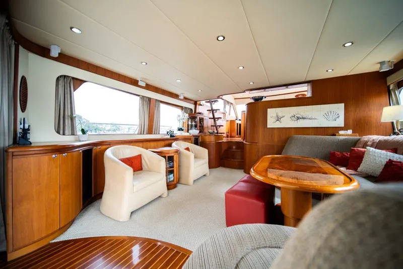 Pama 65 Pilot House Yacht Photos Pics Luxurious interior of 2011 Pama 65 Pilot House yacht with elegant seating and wooden accents.