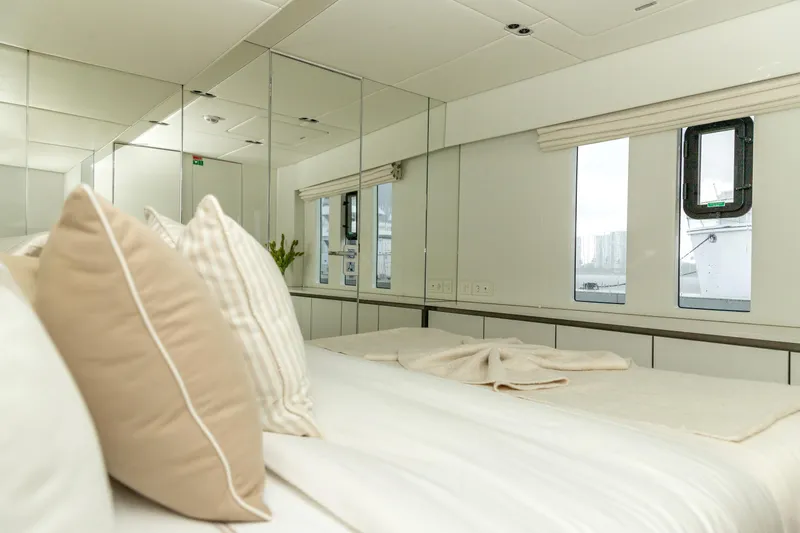 Fat Cat Yacht Photos Pics Luxurious bedroom interior of 2024 Sunreef 80 Power Cat yacht with elegant decor.