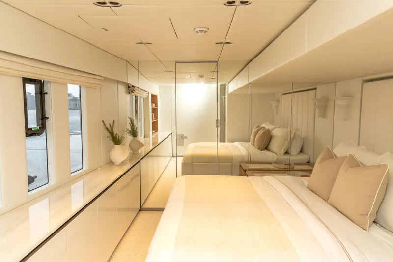 Fat Cat Yacht Photos Pics Luxurious bedroom interior of 2024 Sunreef 80 Power Cat yacht, featuring elegant design and neutral tones.