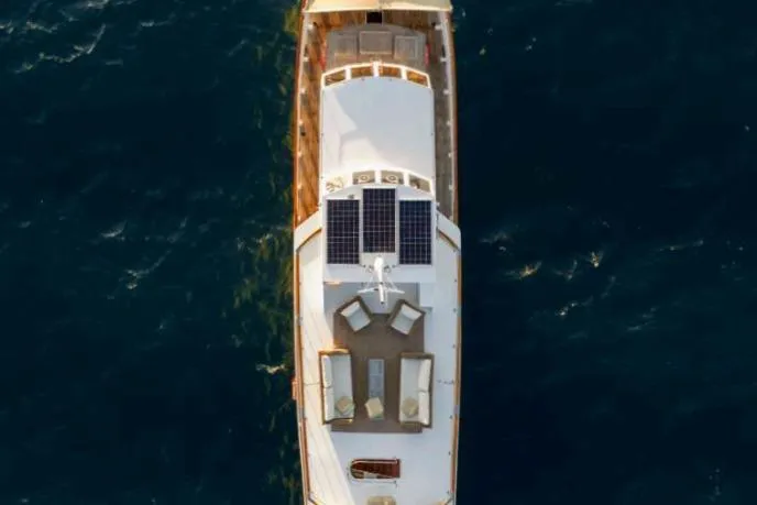 Deramore Yacht Photos Pics Aerial view of 1971 Dagless Ambassador yacht with solar panels on open sea.