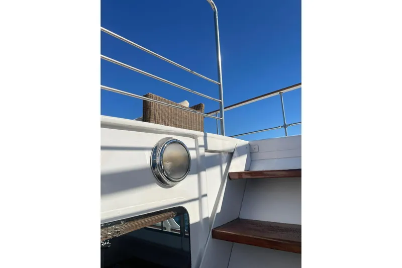 Deramore Yacht Photos Pics 1971 Dagless Ambassador yacht deck with stairs and railing under clear blue sky.