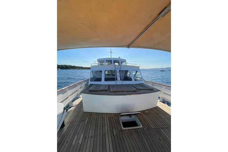 Deramore Yacht Photos Pics 1971 Dagless Ambassador yacht on open water, featuring wooden deck and cabin view.