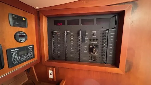 Wasabi Pea Yacht Photos Pics Electrical panel inside a 2003 J Boats J/46 sailboat, featuring various switches and controls.